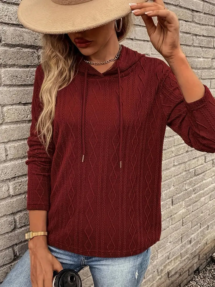 Adeline hoodie styled with jeans and coffee cup, front view