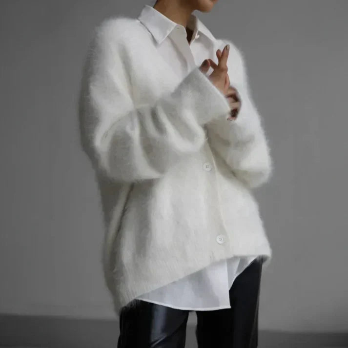 Adeline fuzzy cardigan in white layered over a white shirt