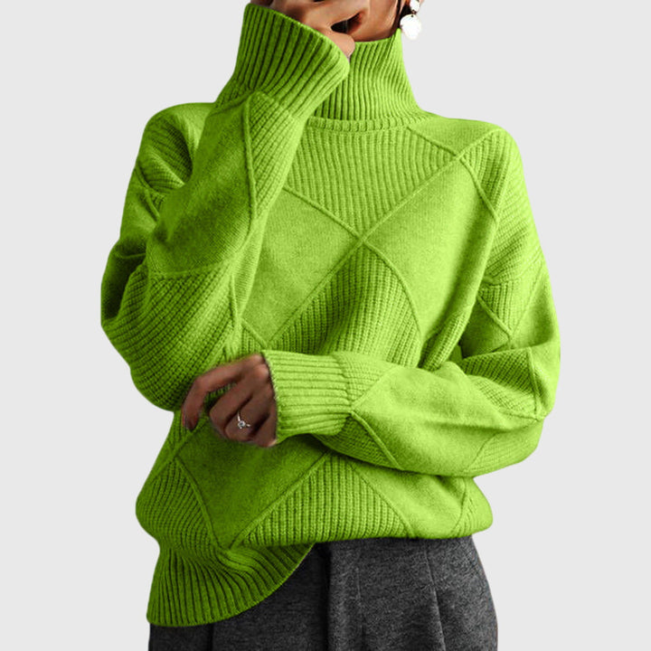 Model wearing lime green oversized turtleneck sweater with arms crossed, front view