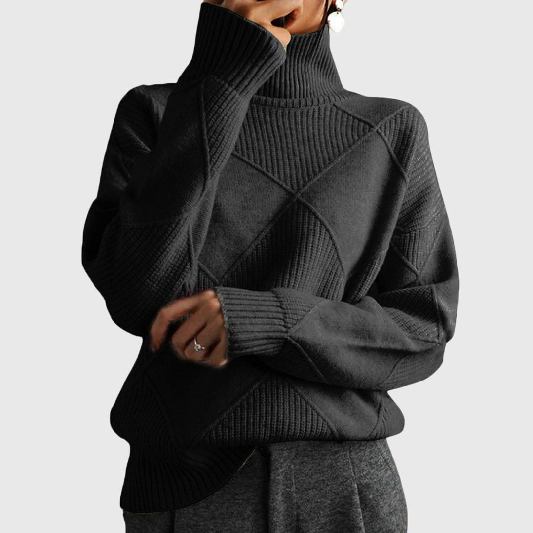 Model wearing charcoal gray oversized turtleneck sweater with arms crossed, front view
