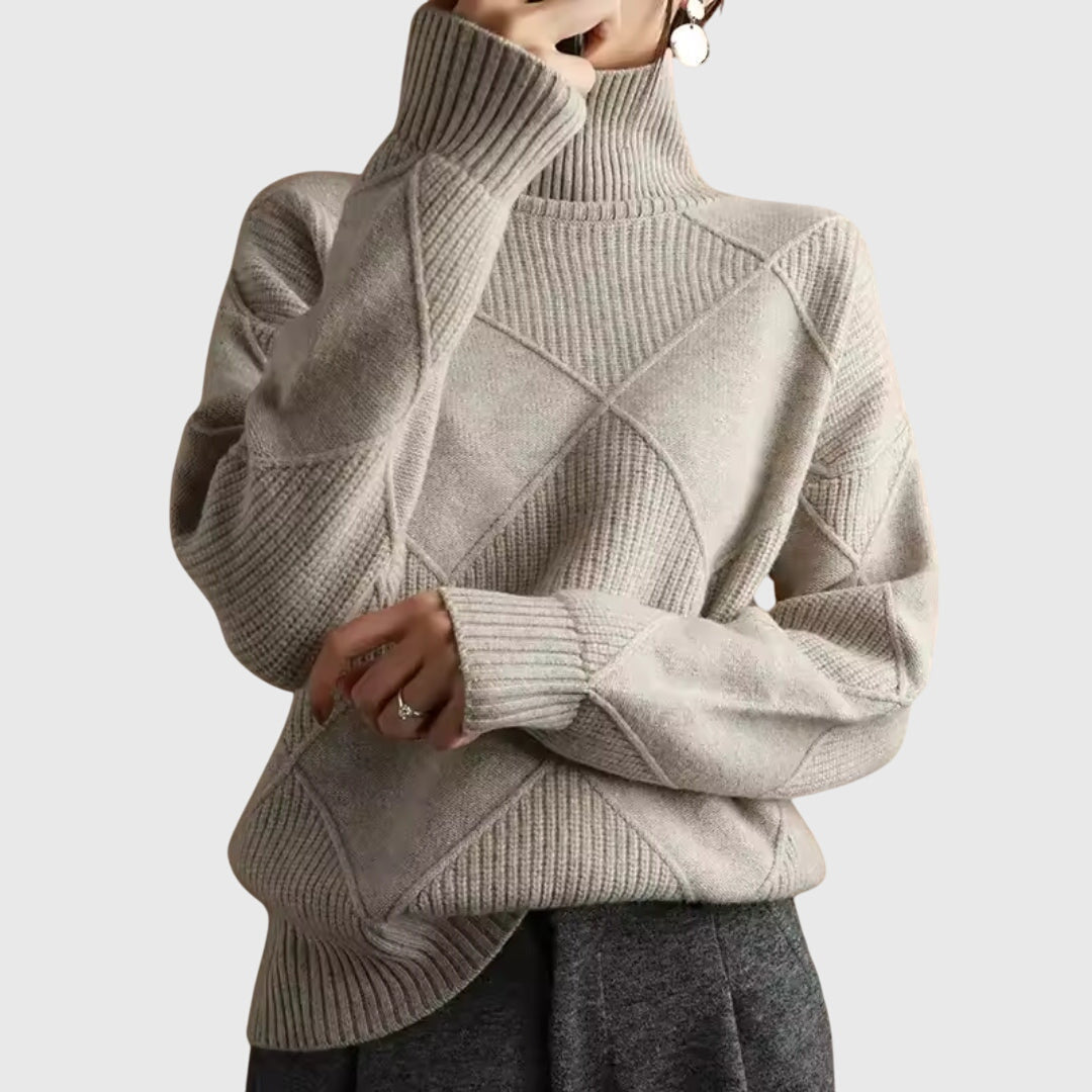 Model wearing beige oversized turtleneck sweater with arms crossed, front view