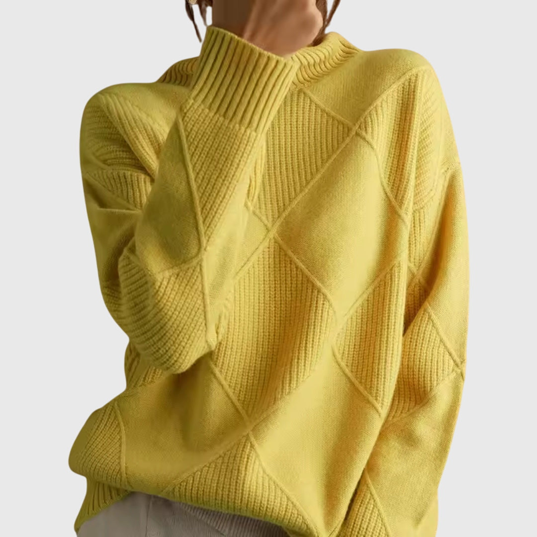 Close-up of yellow turtleneck sweater shoulder and diamond knit pattern