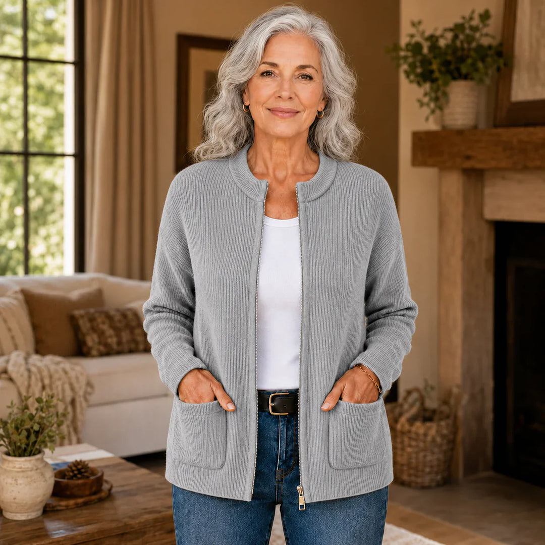 Gray ribbed knit zip-up cardigan on model, front view with hands in pockets