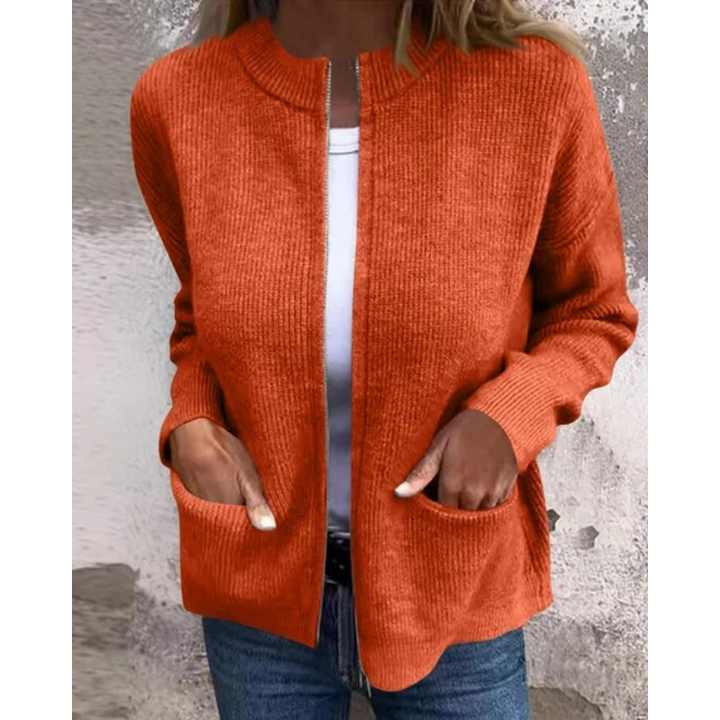 Orange ribbed knit zip-up cardigan, close-up front view with pockets