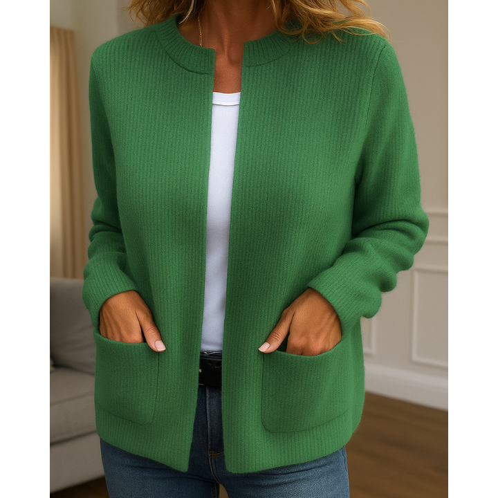 Green ribbed knit zip-up cardigan, close-up front view with pockets