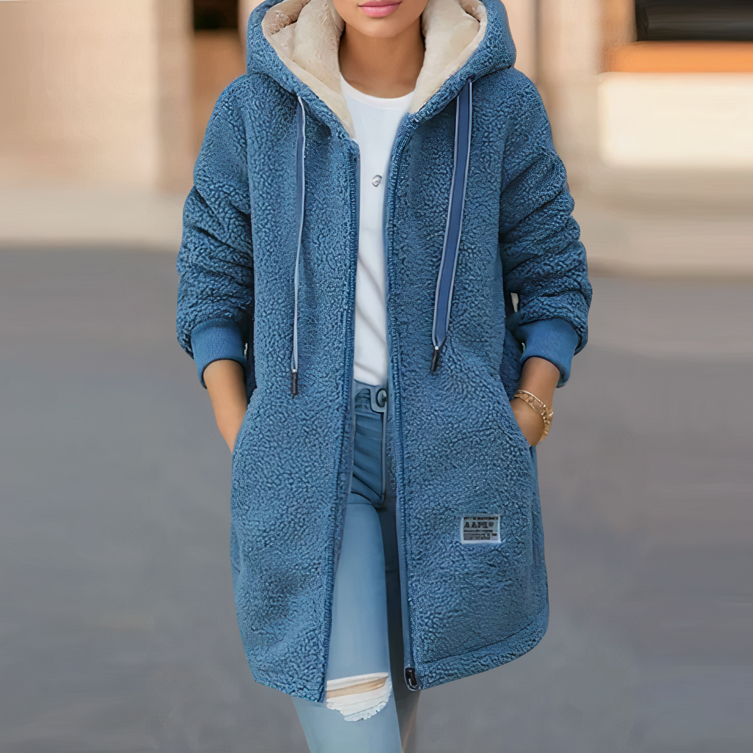 Amara blue hooded sherpa longline jacket, front view with hands in pockets