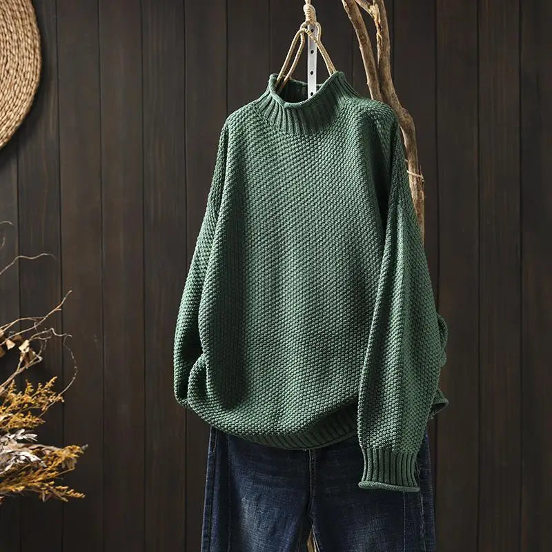Amara oversized mock neck sweater in green, front view on hanger