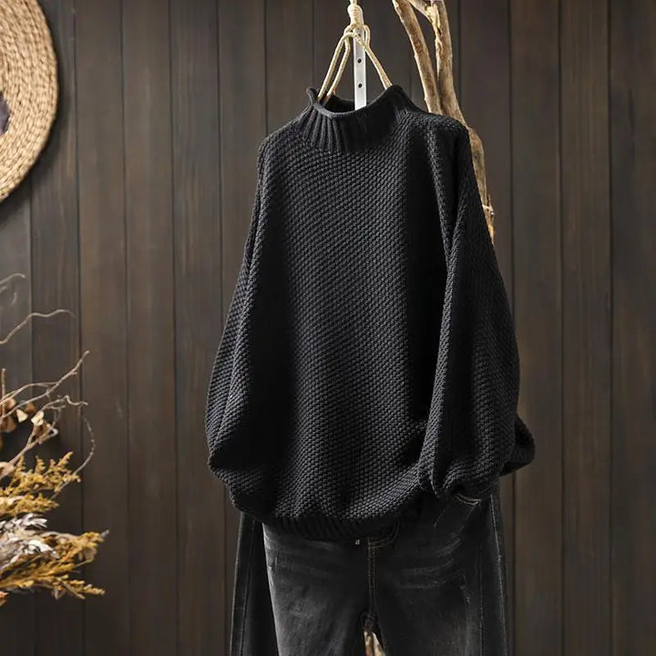 Amara oversized mock neck sweater in black, front view