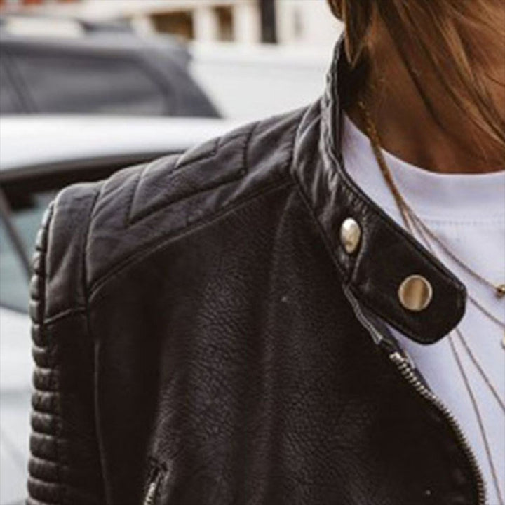 Detail shot of snap-button stand collar and quilted shoulder panel