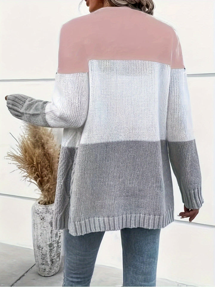 Colette pink colorblock cardigan, back view with holding hand out