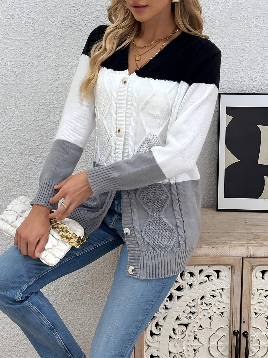 Colette colorblock cardigan, front view leaning on furniture