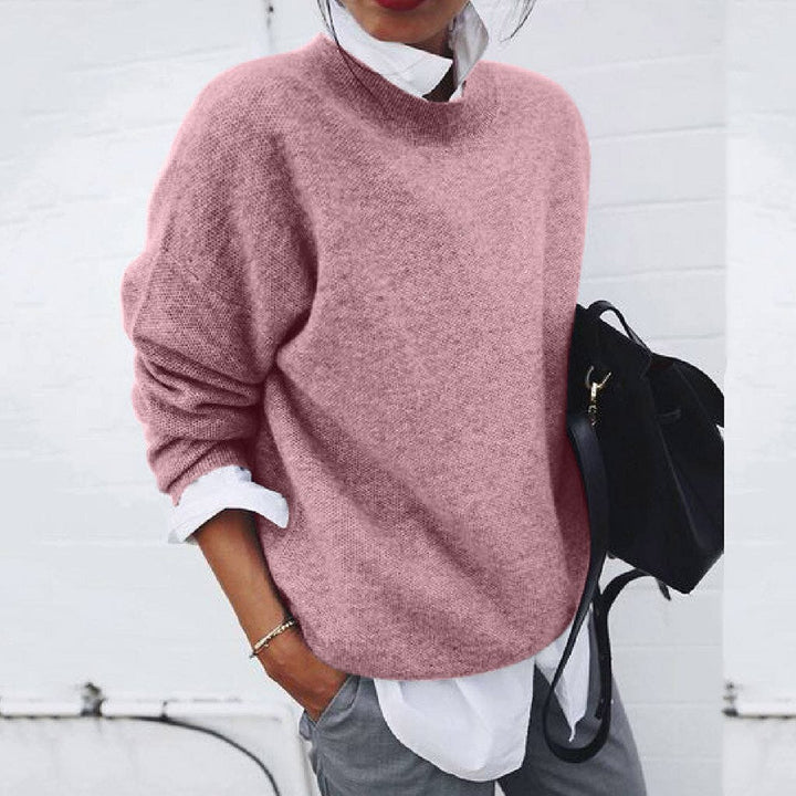 Pink oversized mock neck sweater on model, side view