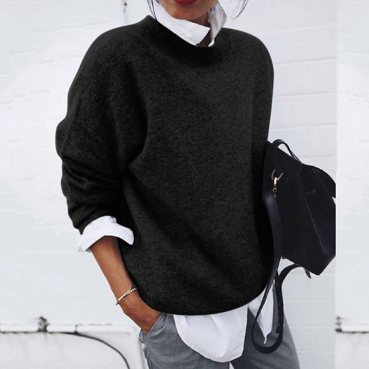 Black oversized mock neck sweater on model, front view