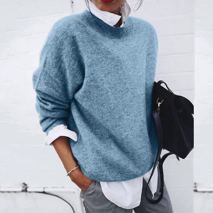 Blue oversized mock neck sweater on model, front view