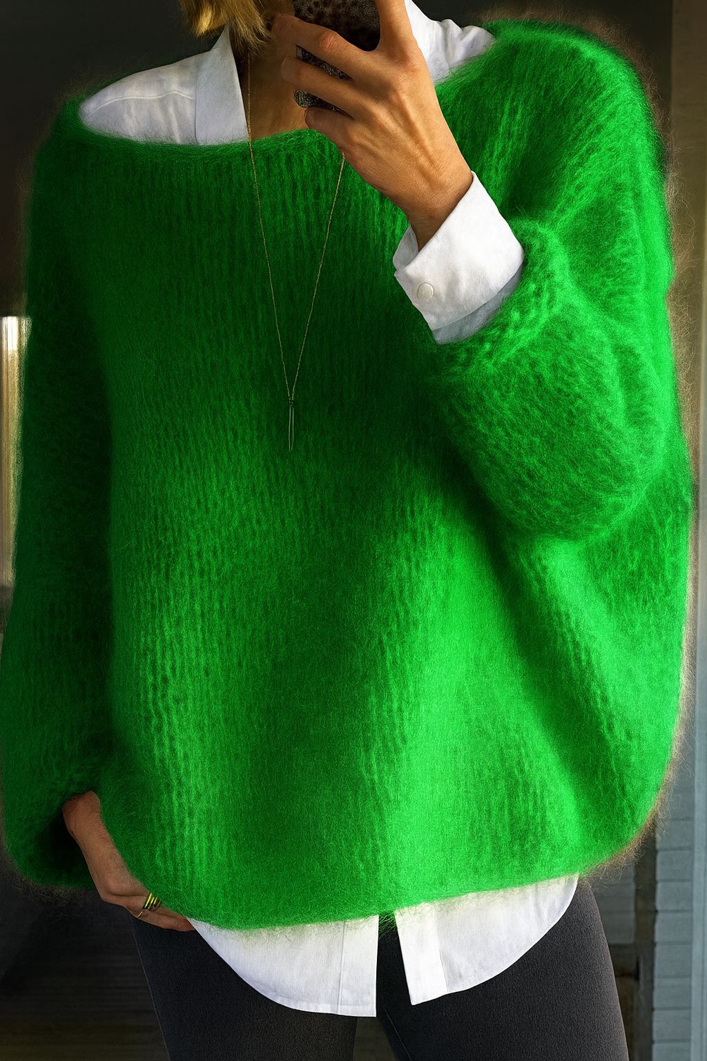 Everly oversized boat neck sweater in green, layered over white shirt, front view