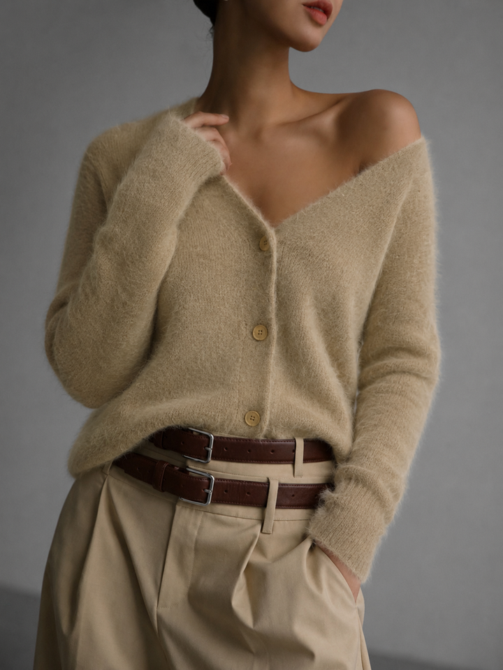 Everly oversized cardigan with button-up front and V-neck, styled with wide-leg trousers and layered belts, front view