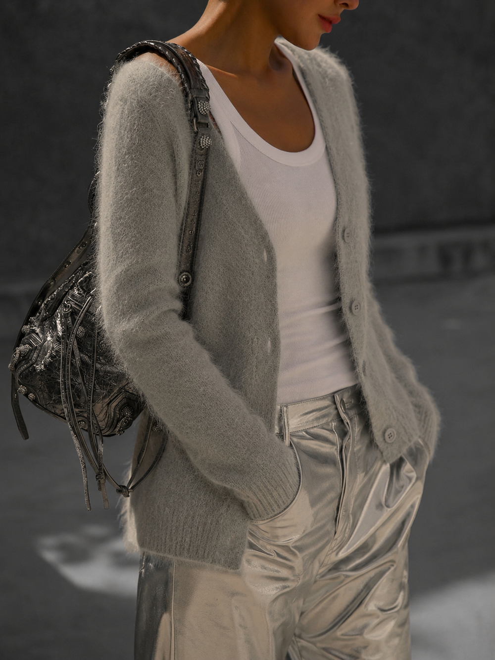 Everly oversized cardigan in grey, side view styled with metallic trousers and a shoulder bag
