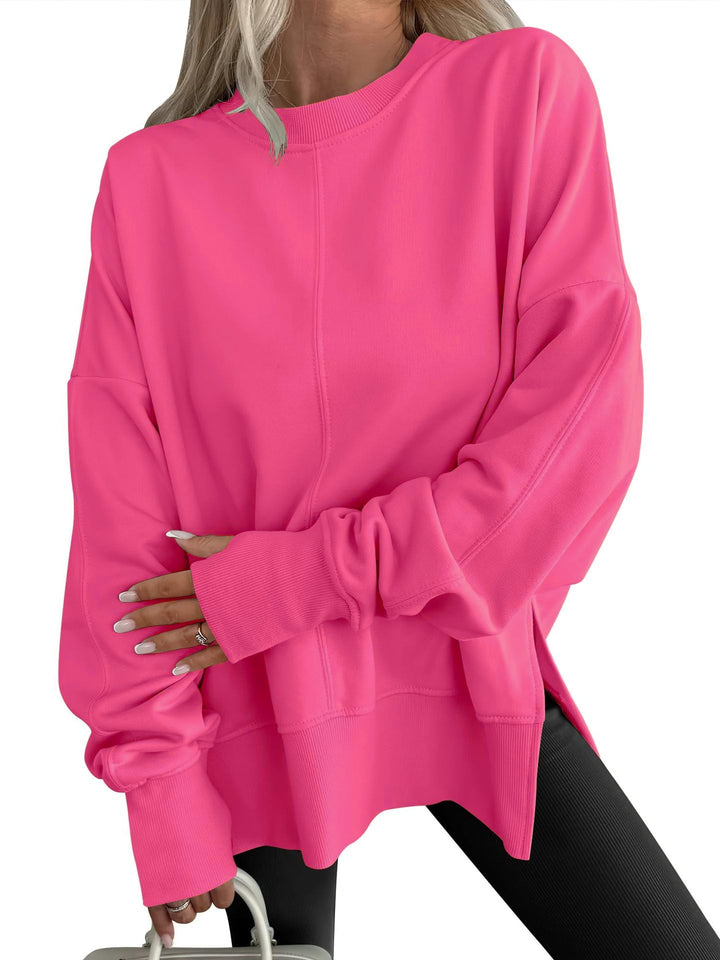 Gwen oversized crew neck sweatshirt in bright pink, front view with side slit hem