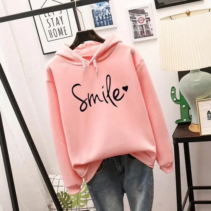 Harlow oversized Smile graphic hoodie in pink, front view on hanger