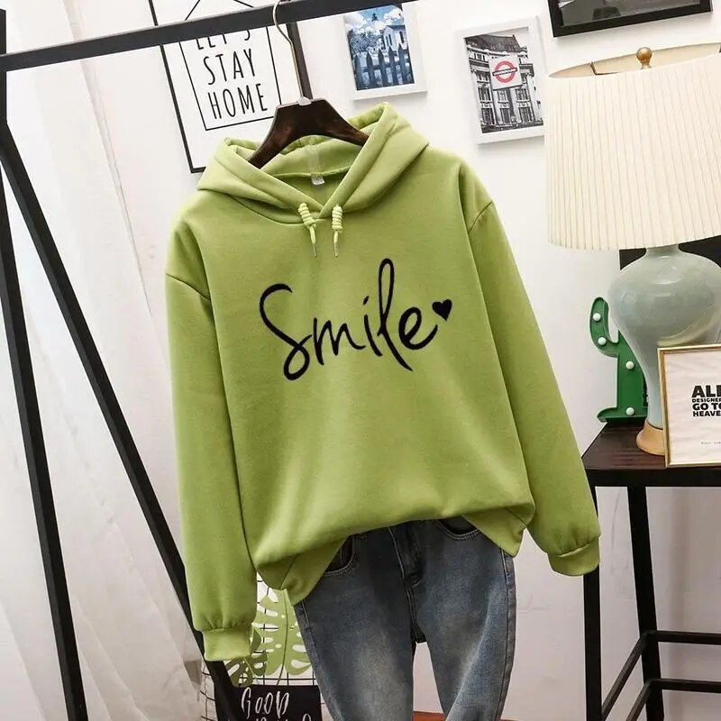 Harlow oversized Smile graphic hoodie in green, front view on hanger