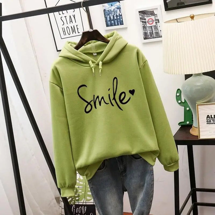 Harlow oversized Smile graphic hoodie in green, front view on hanger