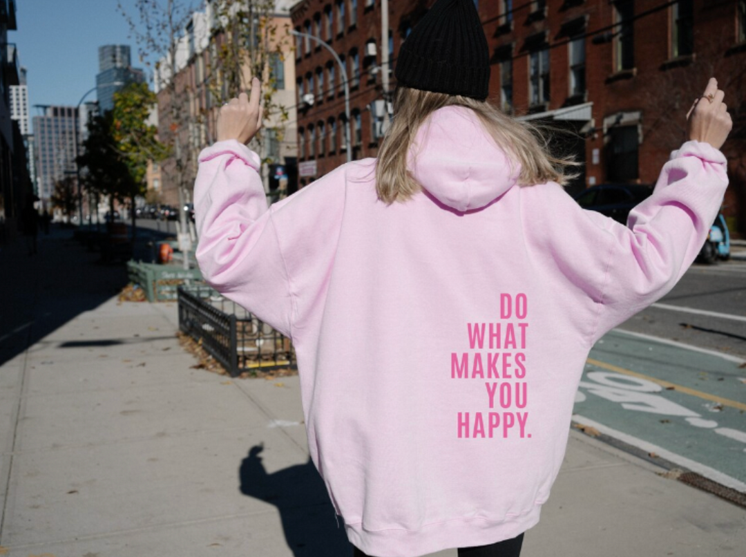 Harlow oversized graphic hoodie in light pink with pink slogan print, street style back view