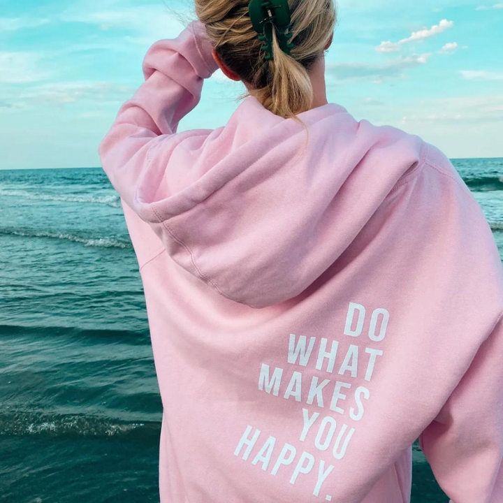 Harlow oversized graphic hoodie in light pink with white slogan print, beach back view