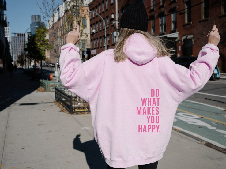 Harlow oversized graphic hoodie in light pink with pink slogan print, street style back view