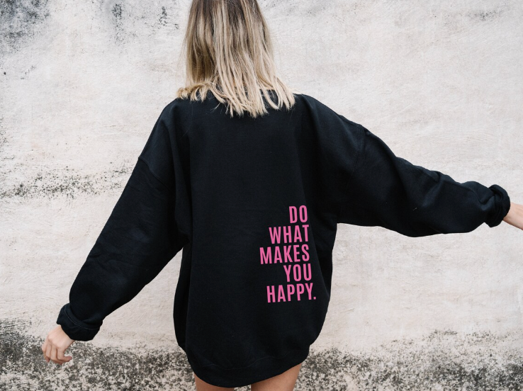 Harlow oversized graphic hoodie in black with pink slogan print, back view close up