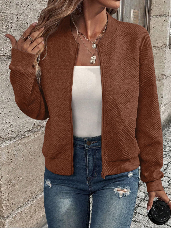 Harlow textured zip-up cropped bomber jacket in brown, front view holding coffee