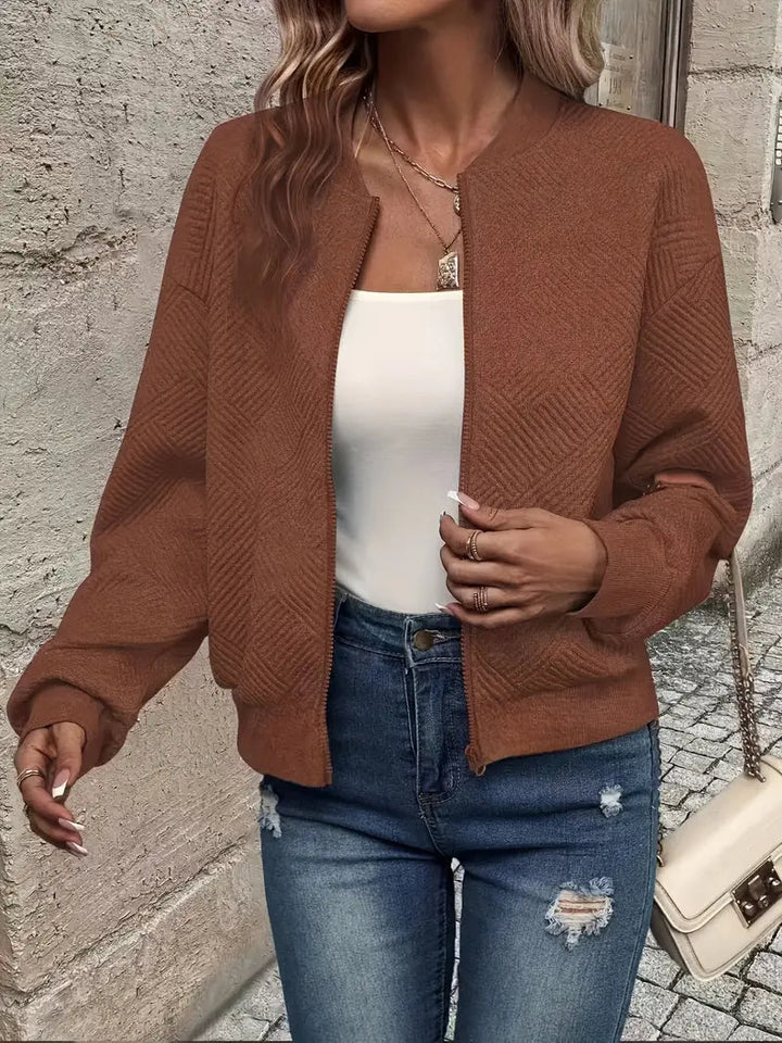 Harlow textured zip-up cropped bomber jacket in brown, close-up front view with bag