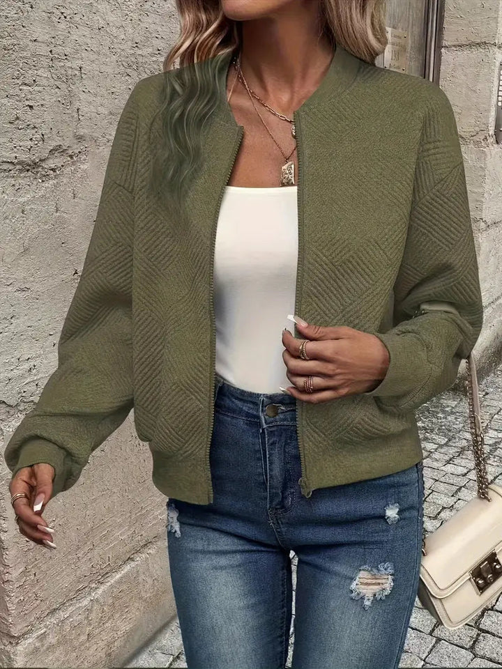 Harlow textured zip-up cropped bomber jacket in olive green, close-up front view with bag