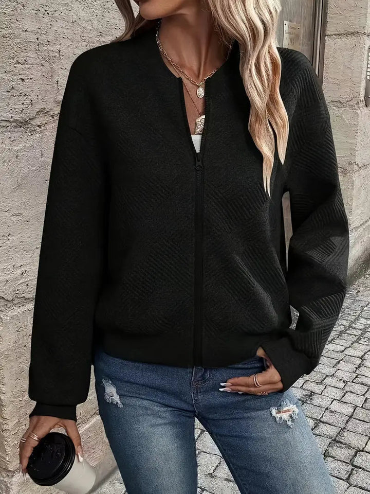 Harlow textured zip-up cropped bomber jacket in black, front view holding coffee
