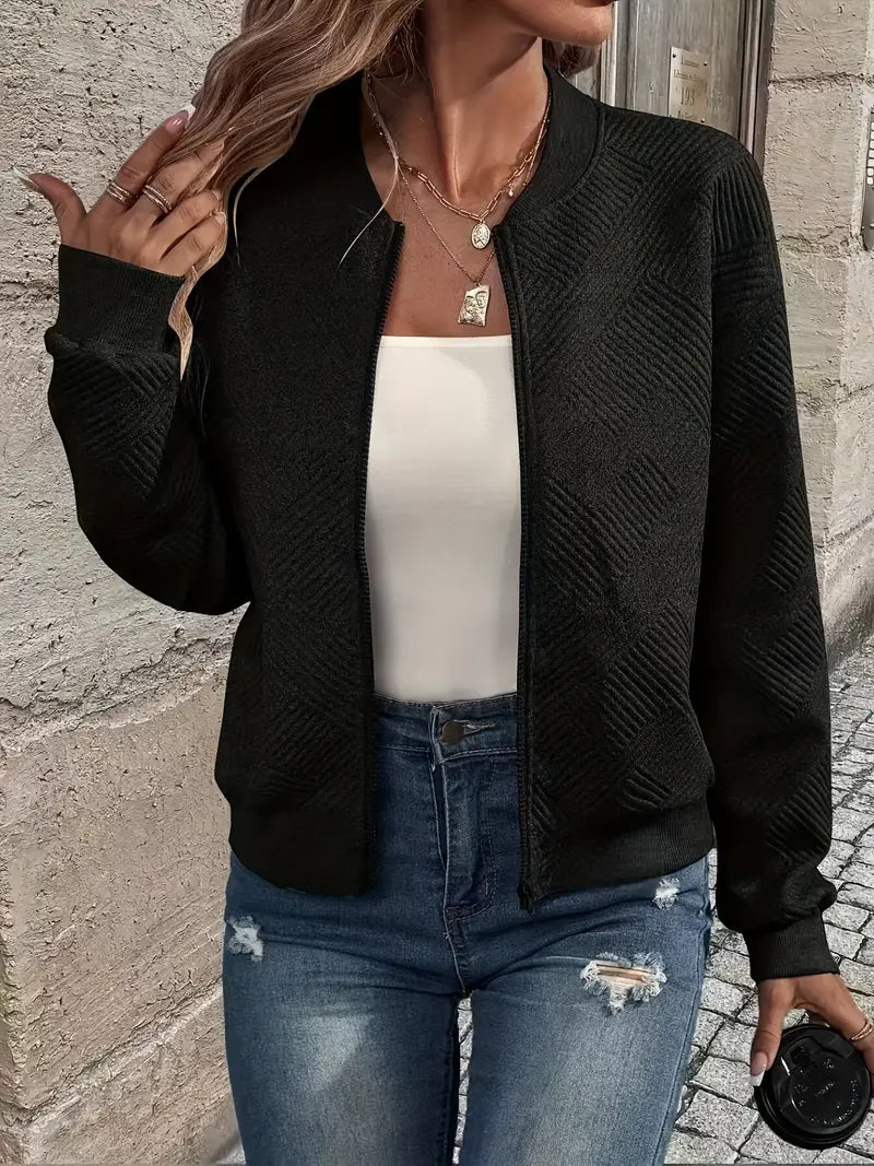 Harlow textured zip-up cropped bomber jacket in black, close-up front view with hand in hair