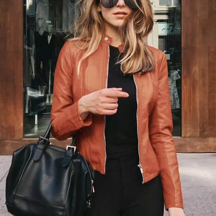 Harper cropped moto jacket in rust orange faux leather, front view