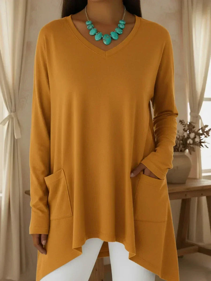 Isolde mustard yellow V-neck loose sweater with irregular hem, front view