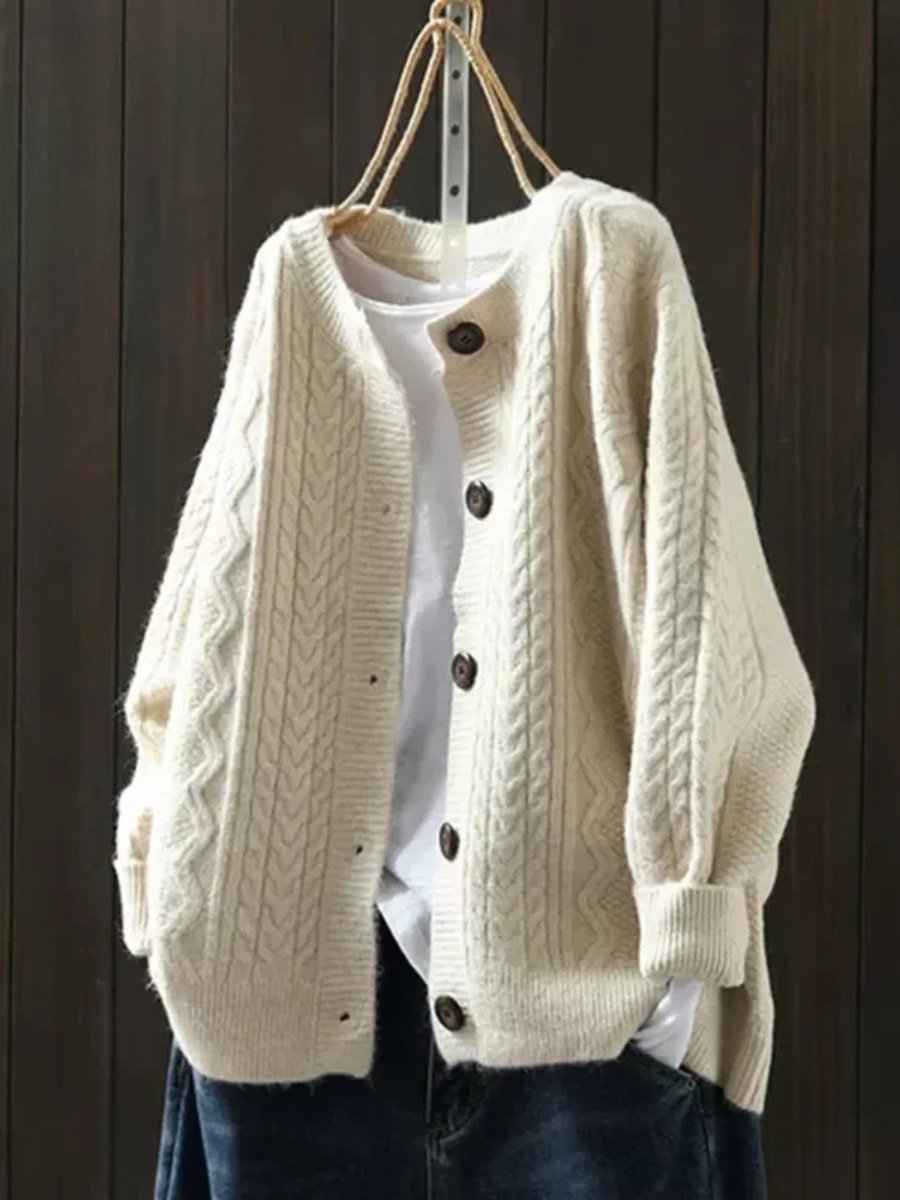 Josephine oversized cable knit cardigan in cream, front view on hanger