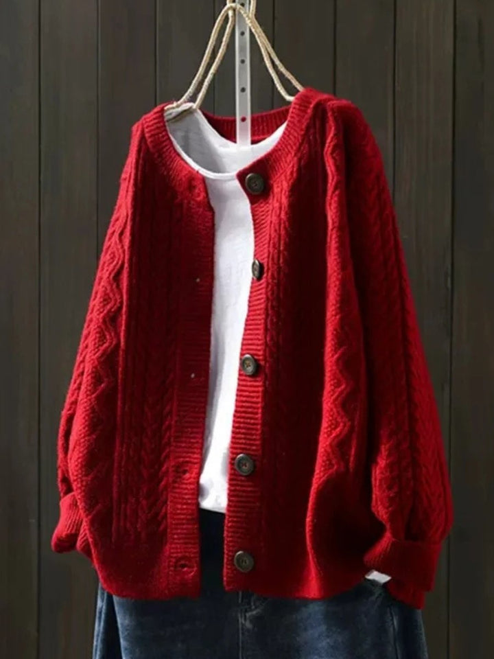 Josephine oversized cable knit cardigan in red, front view on hanger
