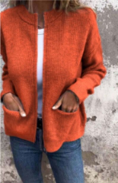 Linda zip-up cardigan in orange, front view with hands in pockets
