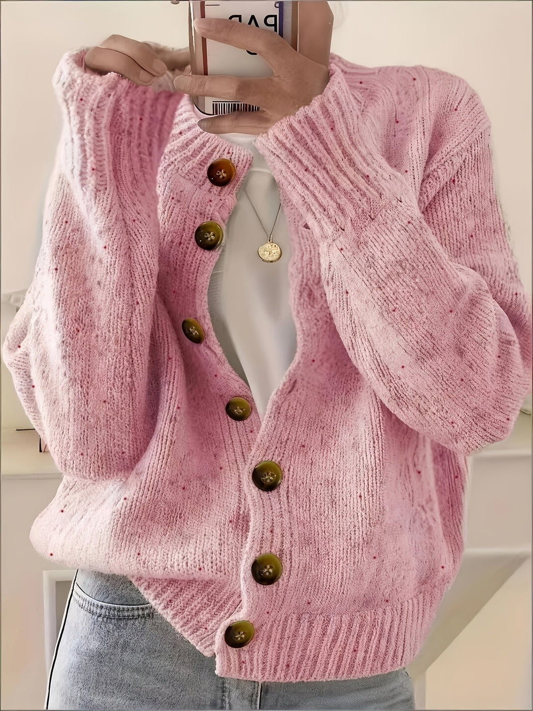 Woman wearing Marama pink speckled knit cardigan, front view with buttons closed