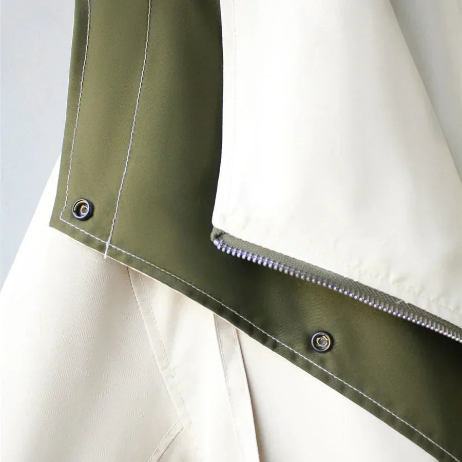 Close-up of zip and snap button closure detail on Margaux trench coat