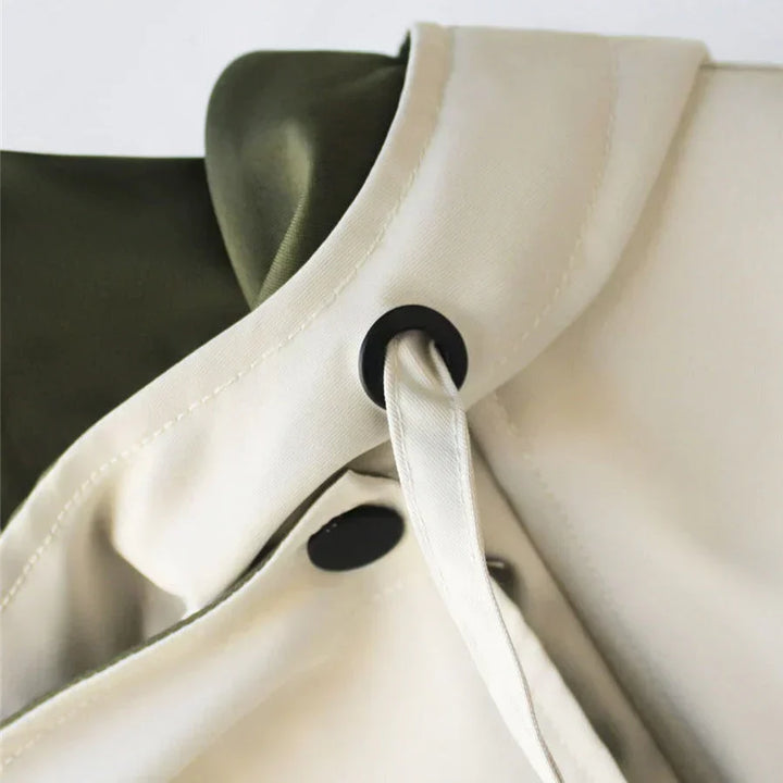 Close-up of collar snap button and drawstring tie on Margaux trench coat