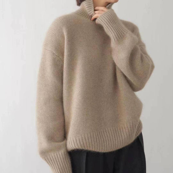 Margot turtleneck sweater in beige, side view with hand at chin