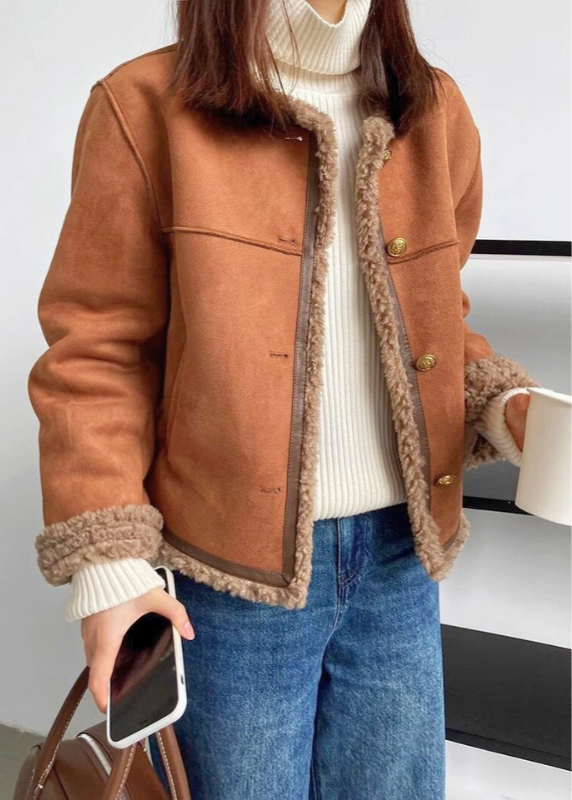 Marigold shearling lined jacket styled with jeans and turtleneck sweater
