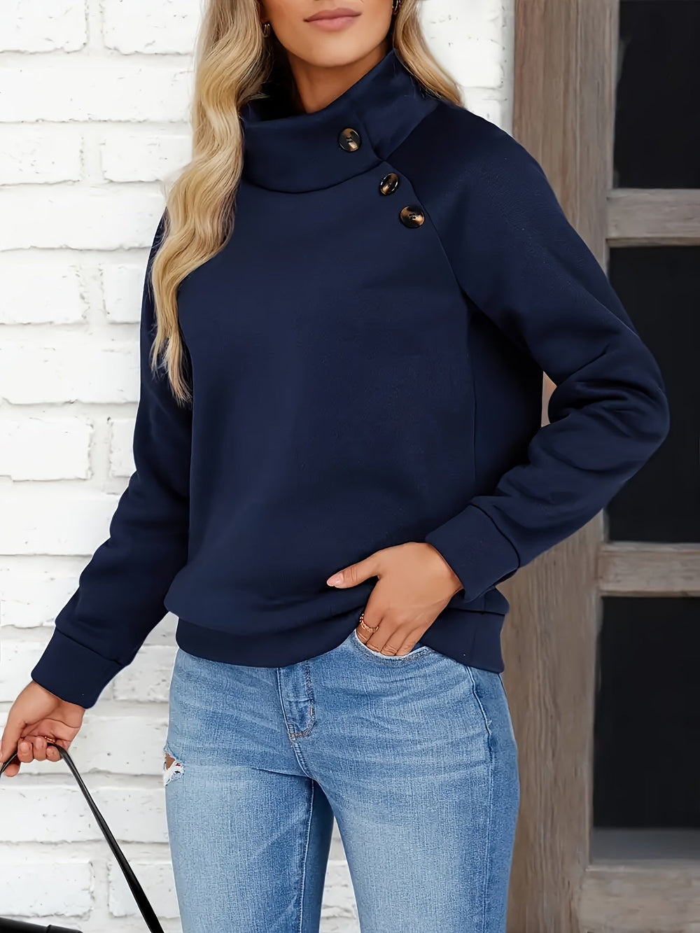 Marisol stand collar sweater with side buttons, front view with hand in pocket