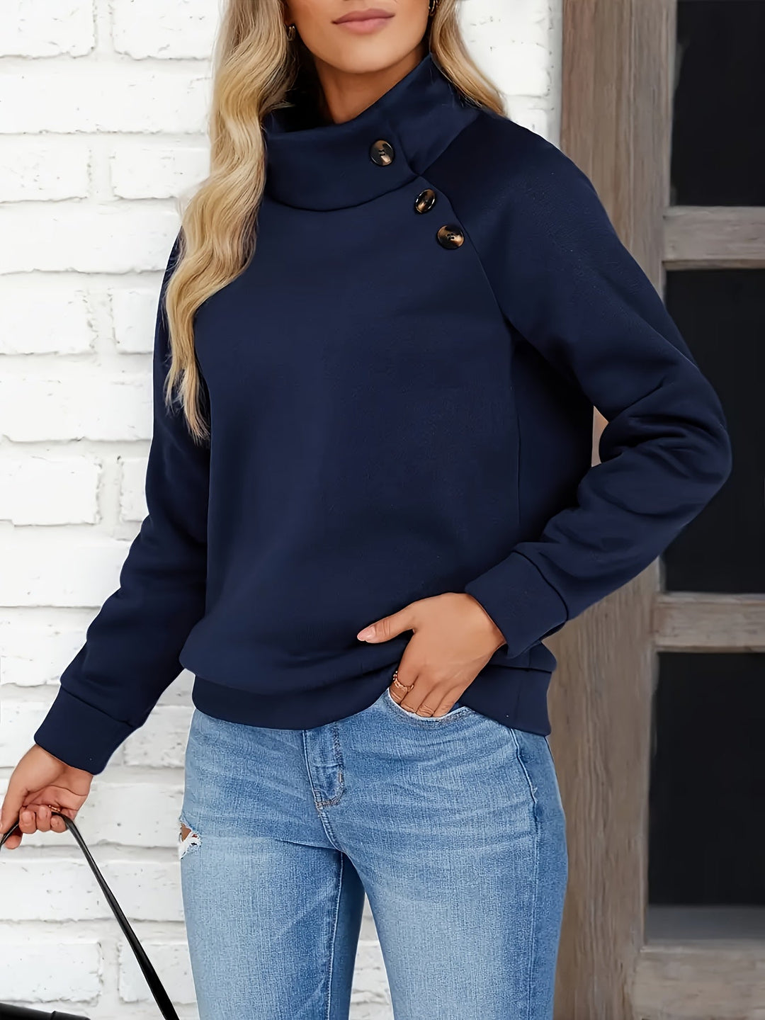 Marisol stand collar sweater with side buttons, front view with hand in pocket