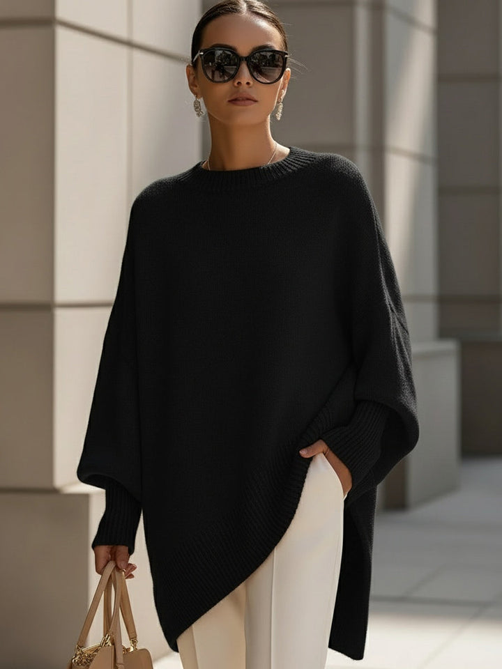 Marlowe oversized asymmetrical poncho sweater in black, front view
