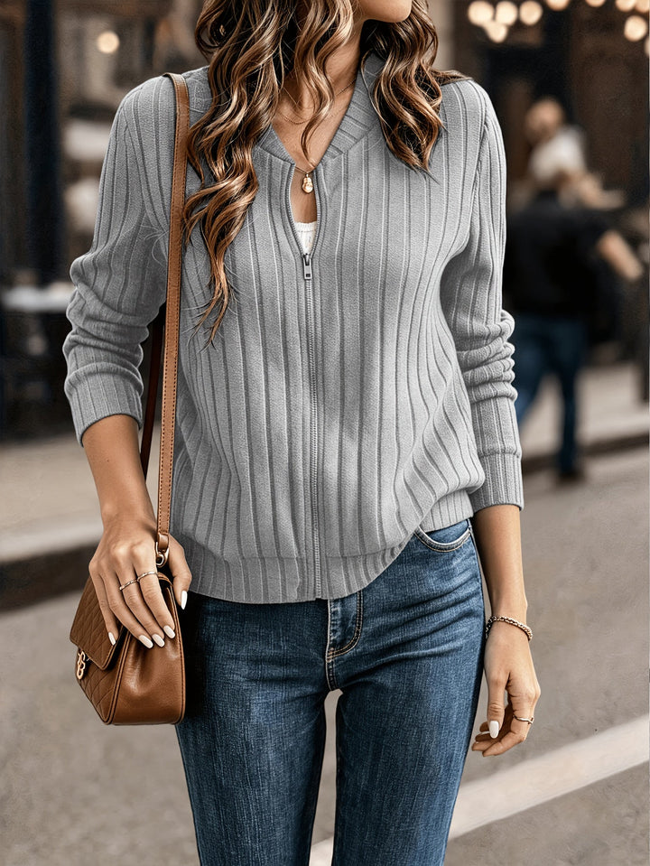 Marlowe ribbed zip-front cardigan in black, styled with crossbody bag