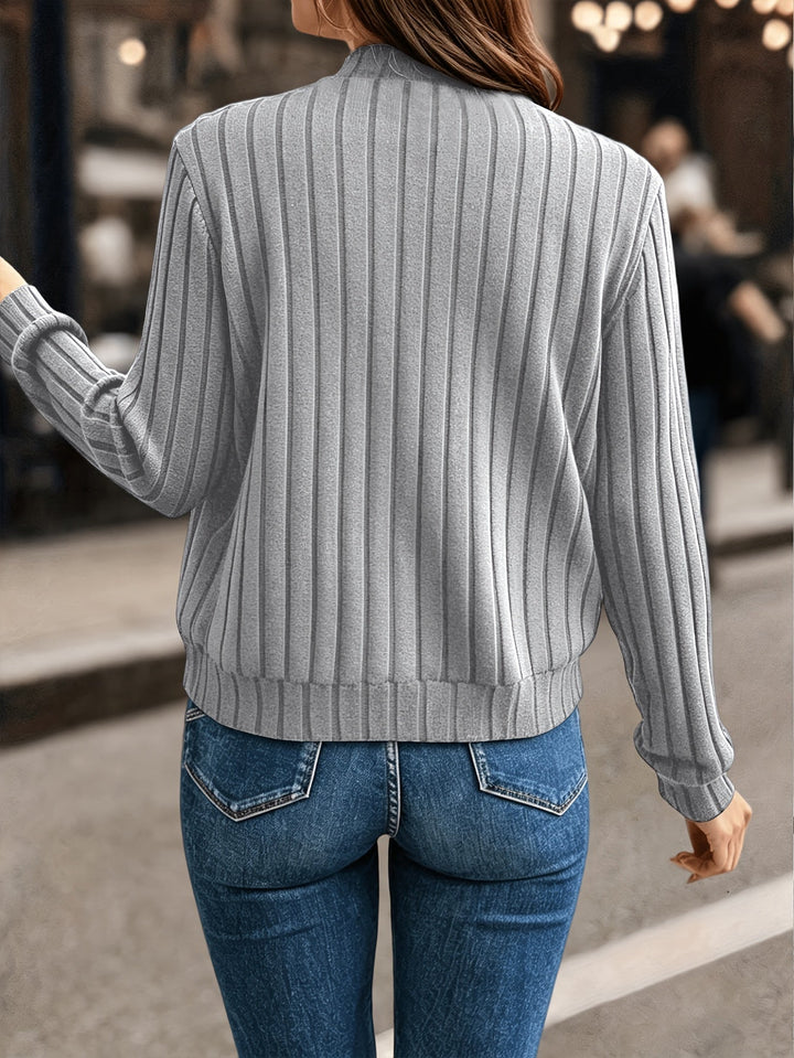 Marlowe ribbed zip-front cardigan in black, styled with crossbody bag