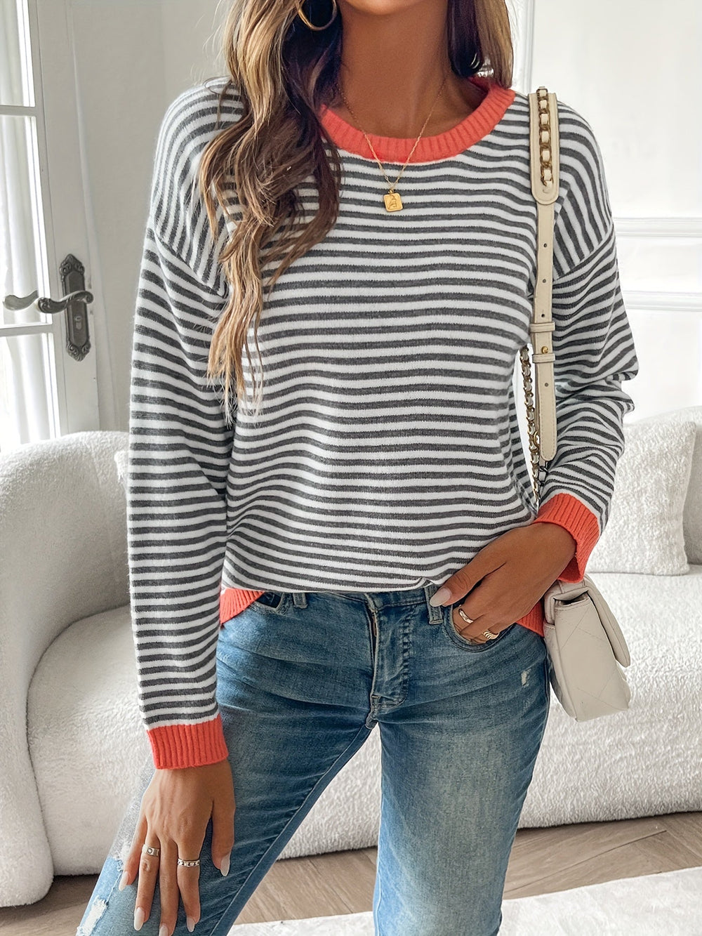 Rosamund striped pullover sweater styled with jeans and a crossbody bag